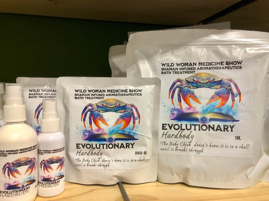 Wild Woman Medicine Show bath treatment packaging and bottles on a wooden surface.